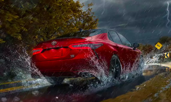 2022 toyota camry whizzing down a rainy street